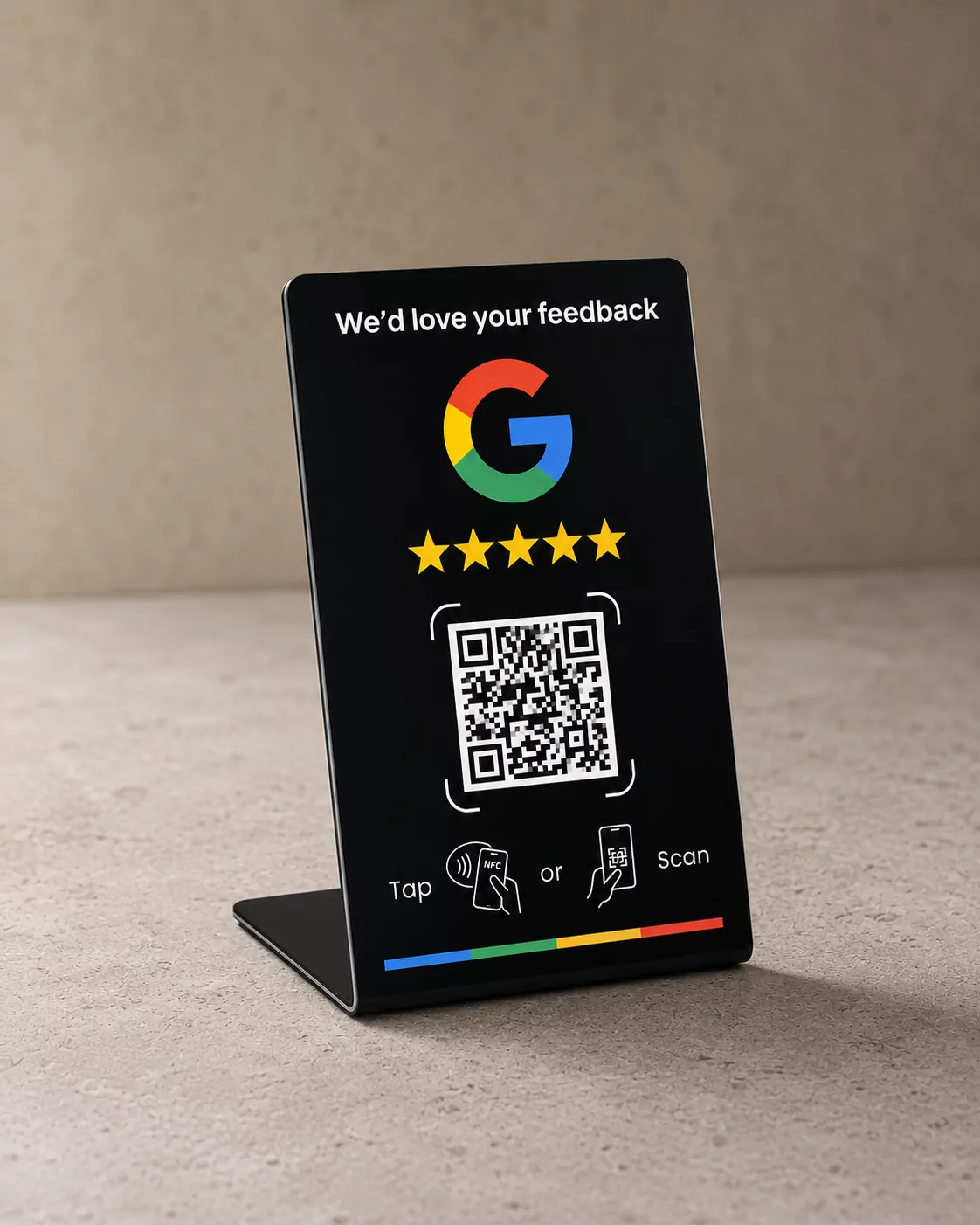 The black Vouchify review stand standing on a pale concrete surface, its face showing the review prompt, five stars, a QR code and the tap or scan line